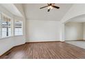 Bright living room featuring hardwood floors, neutral walls, and a bay window at 11642 Moline Ct, Commerce City, CO 80640