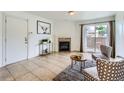 Well-lit living room featuring tile floors, a fireplace, and sliding glass doors to a balcony at 10251 W 44Th Ave # 8-102, Wheat Ridge, CO 80033