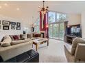 Spacious living room with high ceilings, large windows with great view, cozy fireplace, and comfortable seating at 11526 Green Cir, Conifer, CO 80433