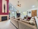 Inviting living room with fireplace, soaring ceilings, large windows with views, and plush sectional sofa at 11526 Green Cir, Conifer, CO 80433