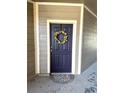 Purple front door with wreath, located in a condo building at 17346 Nature Walk Trail # 105, Parker, CO 80134