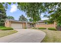 Inviting home with lush landscaping, brick accents, and a spacious front yard, creating curb appeal at 888 E Davies Ave, Centennial, CO 80122