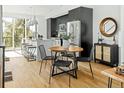 Stylish open-concept kitchen and dining area featuring stainless steel appliances and natural light at 1682 Tabor St, Lakewood, CO 80215