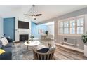 Inviting living room with fireplace, ceiling fan, and view of the dining area at 2504 S Victor St # E, Aurora, CO 80014