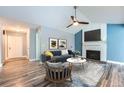 Cozy living room with fireplace, ceiling fan and stylish decor at 2504 S Victor St # E, Aurora, CO 80014