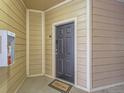 Welcoming front door, complete with welcome mat, offers a secure and inviting entry at 5755 N Genoa Way # 14-105, Aurora, CO 80019