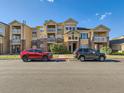 Attractive townhouses featuring a combination of tan siding and brick, accented by a private balcony at 5755 N Genoa Way # 14-105, Aurora, CO 80019