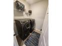 Convenient laundry room equipped with a modern, front-loading washer and dryer at 5755 N Genoa Way # 14-105, Aurora, CO 80019