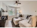 Cozy living room featuring a plush sofa, fireplace, and abundant natural light from large windows at 5755 N Genoa Way # 14-105, Aurora, CO 80019