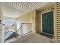 Inviting condo entrance with a covered landing, secure front door, and neighborhood views at 12288 W Dorado Pl # 301, Littleton, CO 80127