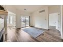 Bright, airy living room with a sliding glass door to a balcony and wood-look floors at 12288 W Dorado Pl # 301, Littleton, CO 80127