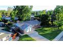 Aerial view of a charming brick home with a spacious yard and mature trees in a quiet neighborhood at 820 Cottonwood Ave, Centennial, CO 80121