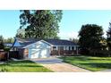 Charming brick home with a well-manicured front yard and a two-car garage at 820 Cottonwood Ave, Centennial, CO 80121