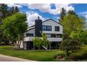 Modern home showcasing a sleek exterior, with lush landscaping, and beautiful trees creating a private atmosphere at 5516 S Havana Ct, Englewood, CO 80111
