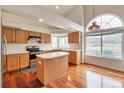 Bright kitchen with an island, stainless steel appliances, and a large window at 20308 E 46Th Ave, Denver, CO 80249