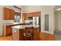 Well-equipped kitchen featuring an island, pantry and stainless steel appliances at 20500 E Hamilton Ave, Aurora, CO 80013