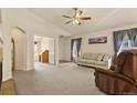 Bright living room with neutral tones, a ceiling fan and an abundance of natural light at 20500 E Hamilton Ave, Aurora, CO 80013