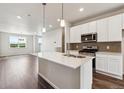 Open kitchen with a spacious island, stainless appliances, and modern finishes at 457 Interlocken Blvd # 105, Broomfield, CO 80021