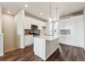 Bright kitchen with a large island, stainless appliances, and sleek white cabinetry at 457 Interlocken Blvd # 105, Broomfield, CO 80021