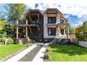 Modern two-story home with a mix of dark and light materials, and a paved driveway at 2478 S Lafayette St, Denver, CO 80210