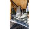 Covered porch with two rocking chairs and a modern metal railing at 2478 S Lafayette St, Denver, CO 80210
