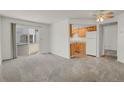 Open-concept living area seamlessly connecting to the kitchen and patio at 17034 E Tennessee Dr # 106, Aurora, CO 80017