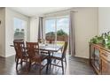 Bright dining area with wood floors and sliding glass door to backyard at 2682 E 161St Pl, Thornton, CO 80602