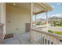 A welcoming front porch with classic railing details offers a view of the quiet, residential neighborhood at 2682 E 161St Pl, Thornton, CO 80602