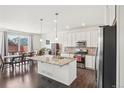 Spacious kitchen featuring an island, stainless steel appliances, and pendant lighting at 2682 E 161St Pl, Thornton, CO 80602