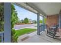 Inviting front porch with rocking chairs and string lights, perfect for relaxing outdoors at 1120 N Calhan Ave, Castle Rock, CO 80104