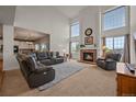 Bright living room with tall ceilings, brick fireplace, and large windows offering plenty of natural light at 1120 N Calhan Ave, Castle Rock, CO 80104