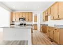 Bright kitchen features wood cabinets, stainless steel appliances, and granite countertops at 39730 Congress Ln, Elizabeth, CO 80107