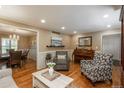 Open living room with hardwood floors connects to dining area, featuring recessed lights, and traditional decor at 7169 S Grape Ln, Centennial, CO 80122