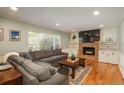 Bright living room with a large window, fireplace, built-ins, and a comfortable sectional sofa at 7169 S Grape Ln, Centennial, CO 80122