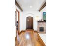 View of living room with wooden beams, brick fireplace, and hardwood floors at 2235 S Fillmore St, Denver, CO 80210