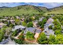 Aerial view of the home with a mountain view, nestled in a neighborhood surrounded by lush greenery at 4921 Fountain St, Boulder, CO 80304