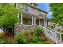 Beautiful home with a covered front porch, stone accents, well-manicured landscaping, and great curb appeal at 4921 Fountain St, Boulder, CO 80304
