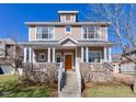 Inviting two-story home with a covered front porch, stone accents, and well-maintained lawn at 4921 Fountain St, Boulder, CO 80304