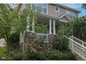 Beautiful home featuring a stone base, lush landscaping, and a welcoming front porch at 4921 Fountain St, Boulder, CO 80304