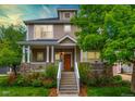 Charming home featuring a welcoming front porch with stone accents, white columns, and beautiful landscaping at 4921 Fountain St, Boulder, CO 80304