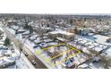 Aerial view of a house and lot in a snow-covered neighborhood at 1435 Quebec St, Denver, CO 80220