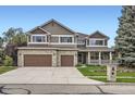 Attractive two-story home featuring brick accents, a covered porch, and a spacious driveway at 2215 Parkview Dr, Longmont, CO 80504