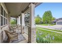 Relaxing front porch with seating area, offering a peaceful view of the neighborhood at 2215 Parkview Dr, Longmont, CO 80504