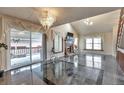Bright living room with high ceilings, fireplace, and sliding glass doors to backyard at 710 Kittredge St, Aurora, CO 80011
