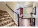 Welcoming entryway featuring hardwood floors, a staircase, and a view into the living room at 853 Jenny Ln, Berthoud, CO 80513