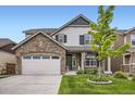 Charming two-story home with stone accents, green shutters, and a beautifully landscaped front yard at 853 Jenny Ln, Berthoud, CO 80513