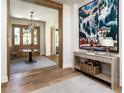 Elegant foyer with beautiful hardwood floors, a decorative table, and stunning artwork creating a welcoming atmosphere at 2409 S Fillmore St, Denver, CO 80210