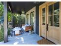 Cozy front porch with a comfortable cushioned bench, stylish accent pieces, and a view of the lush surrounding greenery at 2409 S Fillmore St, Denver, CO 80210
