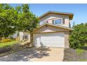 Charming two-story home with a two-car garage and mature landscaping at 3235 S Newland St, Denver, CO 80227