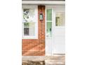 Close-up of exterior brick with address numbers, a white front door, and side glass panel at 3346 W 30Th Ave, Denver, CO 80211